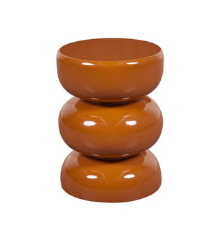 A glossy terracotta-colored three-tiered stacked stool or side table on a plain white background.